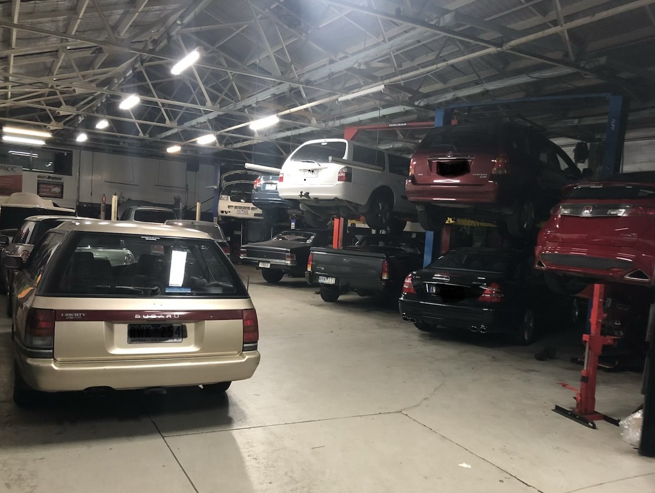 Experienced mechanics servicing multiple vehicles in the Automotive Instincts workshop in Reservoir, Victoria.
