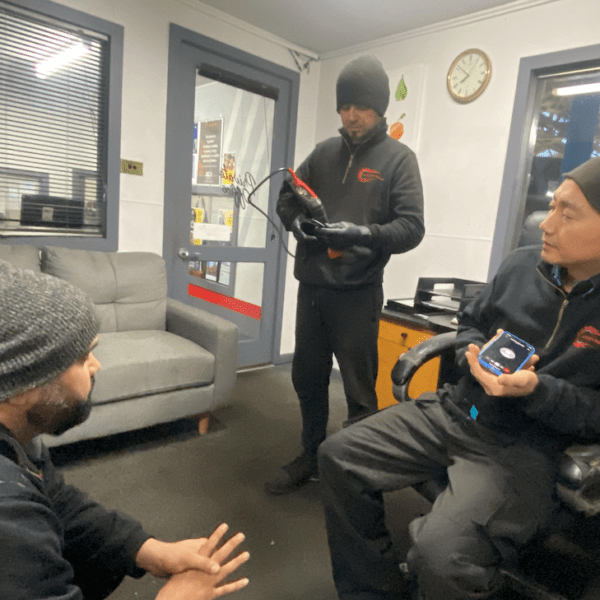 Automotive Instincts technicians discussing vehicle diagnostics and repair solutions at their Reservoir workshop.